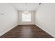 Cozy dining room with hardwood floors, a modern chandelier, and a large window at 13200 Faro Ct # 44, Winter Garden, FL 34787