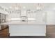 Modern kitchen with white cabinetry, stainless steel appliances, pendant lighting, and a large island at 13200 Faro Ct # 44, Winter Garden, FL 34787