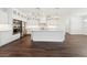 Open-concept kitchen featuring stainless steel appliances, white cabinets, and an expansive island at 13200 Faro Ct # 44, Winter Garden, FL 34787