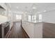 Stylish kitchen with stainless steel appliances, white cabinets, an island, and dark hardwood floors at 13200 Faro Ct # 44, Winter Garden, FL 34787