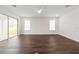 Bright living room with hardwood floors, recessed lighting, ceiling fan and sliding glass doors to the backyard at 13200 Faro Ct # 44, Winter Garden, FL 34787