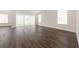 Spacious living room featuring modern windows, hardwood floors, and neutral walls, flooded with natural light at 13200 Faro Ct # 44, Winter Garden, FL 34787