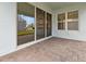 Outdoor patio with brick pavers, sliding glass doors, and a view of the landscaped backyard at 13200 Faro Ct # 44, Winter Garden, FL 34787