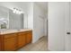 Double sink bathroom with wood cabinets and tiled floors at 13442 Old Dock Rd, Orlando, FL 32828