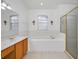 Bathroom with soaking tub, shower, and double vanity at 13442 Old Dock Rd, Orlando, FL 32828