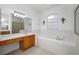 Bathroom features a soaking tub, double vanity, and tiled floors at 13442 Old Dock Rd, Orlando, FL 32828