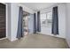Bedroom with grey curtains, carpeting and backyard access at 13442 Old Dock Rd, Orlando, FL 32828