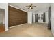 Main bedroom with wood-look wall and neutral carpeting at 13442 Old Dock Rd, Orlando, FL 32828