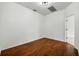 Simple bedroom with hardwood floors and an open doorway at 13442 Old Dock Rd, Orlando, FL 32828