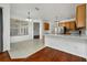 Kitchen features light wood cabinets, white countertops, and tile flooring at 13442 Old Dock Rd, Orlando, FL 32828