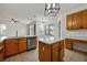 Island kitchen with stainless steel appliances and wood cabinets at 13442 Old Dock Rd, Orlando, FL 32828