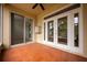 Screened porch with tile flooring and French doors at 13442 Old Dock Rd, Orlando, FL 32828