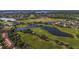 Aerial view of the golf course with several water features and beautiful scenery at 13940 Arclid St, Orlando, FL 32832