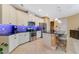 Modern kitchen featuring white cabinets, granite countertops, and a breakfast bar at 13940 Arclid St, Orlando, FL 32832