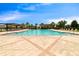 Relaxing community pool is surrounded by lounge chairs and lush landscaping on a bright sunny day at 13940 Arclid St, Orlando, FL 32832