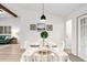 Bright dining room with a white table, chairs and a view into the living room at 1404 N Cove Blvd, Longwood, FL 32750