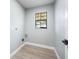 Clean laundry room with light gray walls and wood-look floors at 1404 N Cove Blvd, Longwood, FL 32750