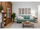 Living area with teal sofa and wood accent wall at 1404 N Cove Blvd, Longwood, FL 32750