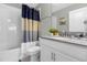 Clean bathroom with a shower/tub combo and updated vanity at 1564 Flange Dr, Davenport, FL 33896