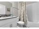 Bathroom with tub shower, toilet, and vanity at 1564 Flange Dr, Davenport, FL 33896