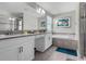 Modern bathroom with double vanity, soaking tub, and walk-in shower at 1564 Flange Dr, Davenport, FL 33896
