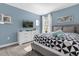 Bedroom with a queen-size bed and gray walls at 1564 Flange Dr, Davenport, FL 33896