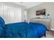 Bright bedroom with a comfortable queen-size bed and large closet at 1564 Flange Dr, Davenport, FL 33896