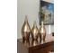 Three decorative gold vases on a dresser at 1564 Flange Dr, Davenport, FL 33896