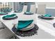 Modern dining room with white table and teal napkins at 1564 Flange Dr, Davenport, FL 33896
