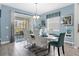 Bright dining room with white table and blue accents at 1564 Flange Dr, Davenport, FL 33896