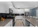Modern kitchen with white cabinets, granite countertops and stainless steel appliances at 1564 Flange Dr, Davenport, FL 33896