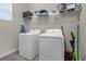 Laundry room with washer, dryer, and shelving at 1564 Flange Dr, Davenport, FL 33896
