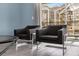 Two dark gray accent chairs with a glass top accent table at 1564 Flange Dr, Davenport, FL 33896