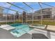 Screened-in pool and spa with lounge chair at 1564 Flange Dr, Davenport, FL 33896