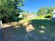 Large backyard with grassy area and mature trees at 1632 Gar St, St Cloud, FL 34771
