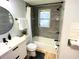 Updated bathroom with gray tile and modern vanity at 1632 Gar St, St Cloud, FL 34771