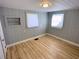 Well-lit bedroom featuring built-in shelving and wood floors at 1632 Gar St, St Cloud, FL 34771