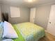 Bright bedroom with light walls and a green bedding set at 1632 Gar St, St Cloud, FL 34771
