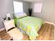 Cozy bedroom featuring a queen bed and white nightstand at 1632 Gar St, St Cloud, FL 34771
