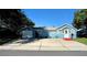 Blue house with a large yard, driveway and garage at 1632 Gar St, St Cloud, FL 34771
