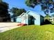 Blue house with a yard, driveway and garage at 1632 Gar St, St Cloud, FL 34771