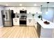 Modern kitchen boasts stainless steel appliances and white cabinets at 1632 Gar St, St Cloud, FL 34771