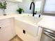 Stylish kitchen with white farmhouse sink and quartz countertops at 1632 Gar St, St Cloud, FL 34771