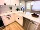 Modern kitchen with white cabinets, quartz counters, and farmhouse sink at 1632 Gar St, St Cloud, FL 34771