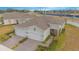 Aerial view of two-car garage home with paver driveway, and landscaped yard at 1987 Key Bay Trl, Kissimmee, FL 34747