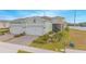 Aerial view of two-car garage home with paver driveway, and landscaped yard at 1987 Key Bay Trl, Kissimmee, FL 34747