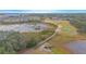 Scenic aerial view of a golf course community featuring a lake and walking bridge at 1987 Key Bay Trl, Kissimmee, FL 34747