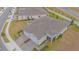 Aerial view of two-car garage home with paver driveway, and landscaped yard at 1987 Key Bay Trl, Kissimmee, FL 34747