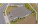 Aerial view of home highlighting roof, screened lanai, and manicured landscaping at 1987 Key Bay Trl, Kissimmee, FL 34747