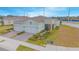 Aerial view of two-car garage home with paver driveway, and landscaped yard at 1987 Key Bay Trl, Kissimmee, FL 34747
